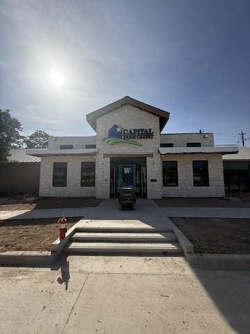 Commercial entrance finished with light-colored stone masonry