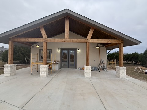 Stone column bases surrounding a timber-framed covered pavilion